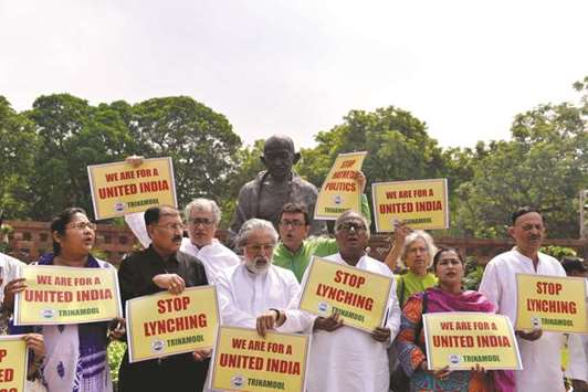Trinamool Congress Party MPs stage a demonstration in front of Mahatma Gandhiu2019s statue at Parliament Building in New Delhi against rising incidents of mob lynchings, yesterday.