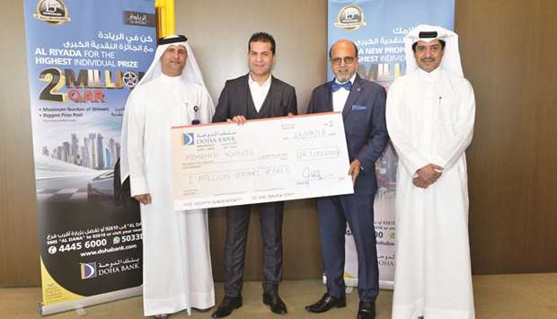 Dr R Seetharaman and other Doha Bank officials with the winner of the 2018 Al Dana savings scheme.