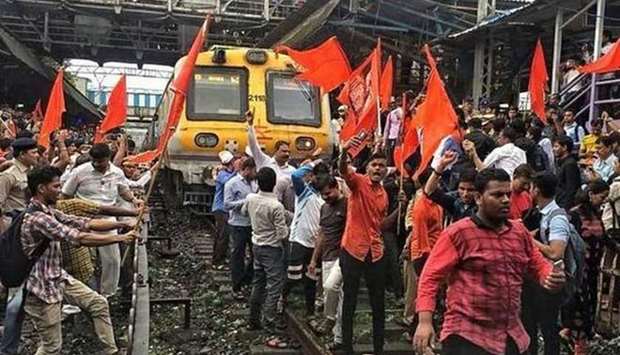 Protesters block a train in Thane, near Mumbai. Picture: The Hindu
