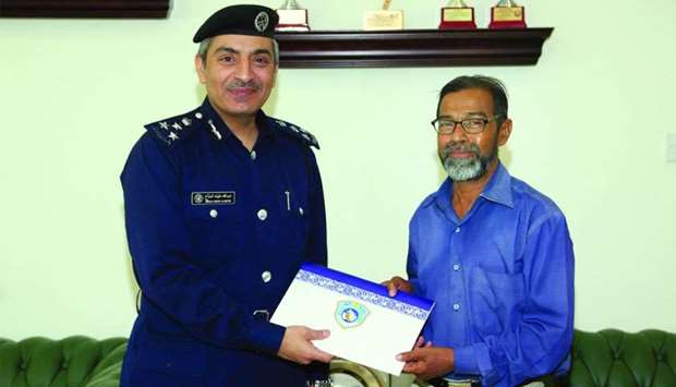 Brigadier Abdullah Khalifa al-Muftah hands over a token of appreciation to K M Abdul Sattar