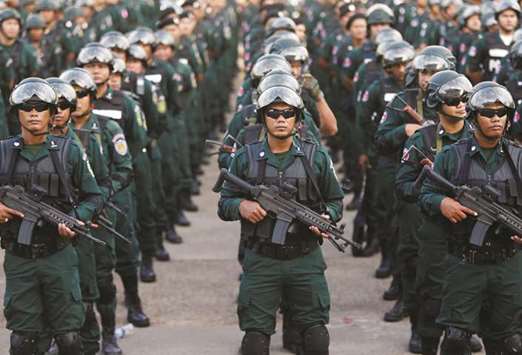 Armed forces display anti-riot gear and assault rifles at the Olympic stadium ahead of a general election this weekend, in Phnom Penh yesterday.