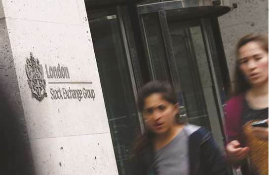 Pedestrians walk past the London Stock Exchange. The FTSE 100 lost 0.7% to 7,658.26 points yesterday.