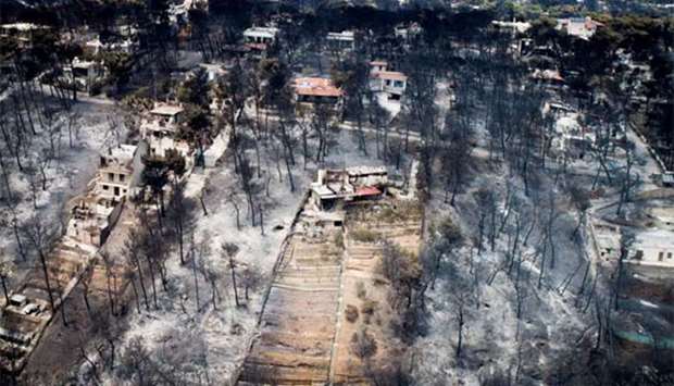 An aerial view shows burnt houses and trees following a wildfire in the village of Mati, near Athens.