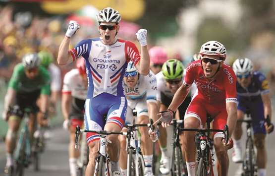 Groupama-FDJ rider Arnaud Demare (left) of France wins the stage ahead of Cofidis rider Christophe Laporte (right) of France on stage 18 of the Tour de France in Pau, France, yesterday. (Reuters)