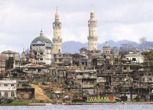 A signage of u2018I love Marawiu2019 is seen in front of damaged houses, buildings and a mosque inside a war-torn Marawi city.