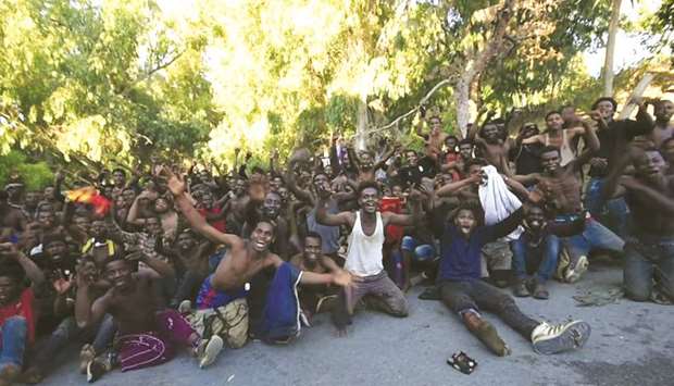 African migrants cheer in this still image taken from video, after they crossed the border from Morocco to Spainu2019s North African enclave of Ceuta.