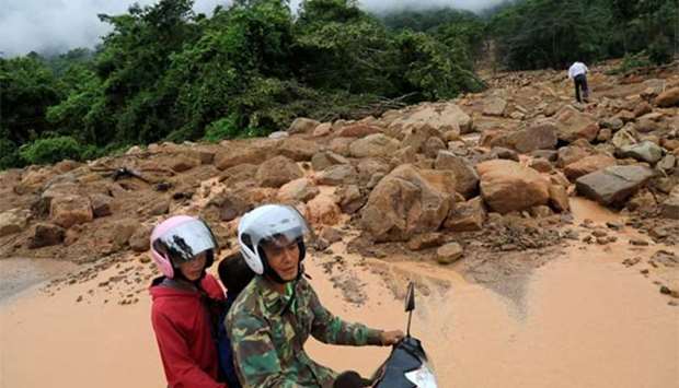 A motor bike passes near a landslide area after the Xepian-Xe Nam Noy hydropower dam collapsed in Attapeu province, on Thursday.