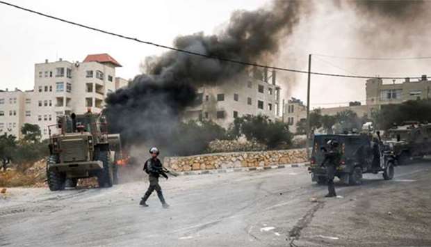 Israeli security forces' vehicles deploy during clashes in the village of Kobar, west of Ramallah in the occupied West Bank, on Friday.