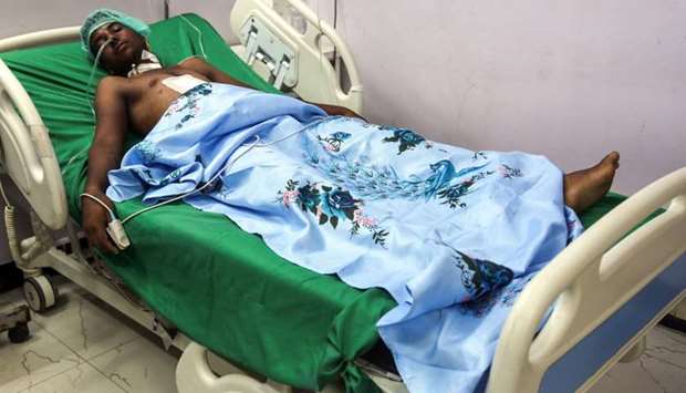 An injured Yemeni fisherman lies in a hospital bed as he receives treatment after being wounded in a reported air strike that hit the Red Sea port city of Hodeidah yesterday.