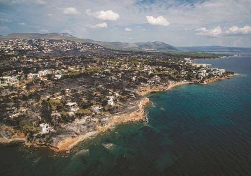 An aerial view shows a burnt area following a wildfire in the village of Mati, near Athens, on July 26. Greece is counting the cost of its deadliest wildfires in living memory, as emergency crews searched incinerated homes and vehicles for the missing after at least 81 people were confirmed to have died.