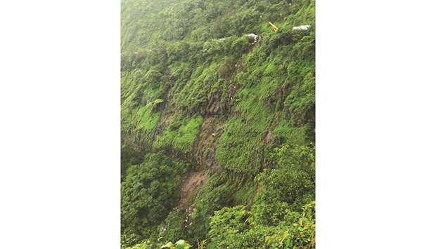 A crane is seen at a mountain road during a rescue operation after a bus fell into a valley near Mahabaleshwar yesterday.