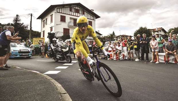 Team Skyu2019s British rider Geraint Thomas, wearing the overall leaderu2019s yellow jersey, rides during the 20th stage of the Tour de France, a 31km individual time-trial between Saint-Pee-sur-Nivelle and Espelette, France, yesterday. (AFP)