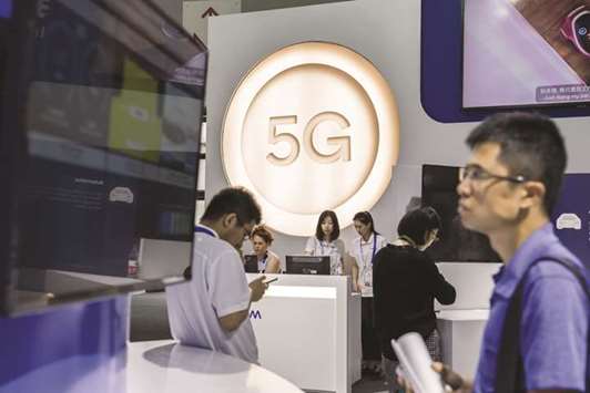 Visitors look at the Qualcomm display area at the Mobile World Congress 2018 in Shanghai. With a 5G rollout coming and China determined to be a global leader in this field, China Tower will need buckets of cash to expand.