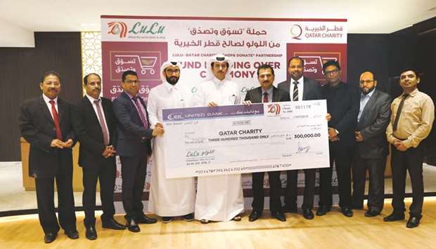 QC and LuLu officials at the cheque handover ceremony.