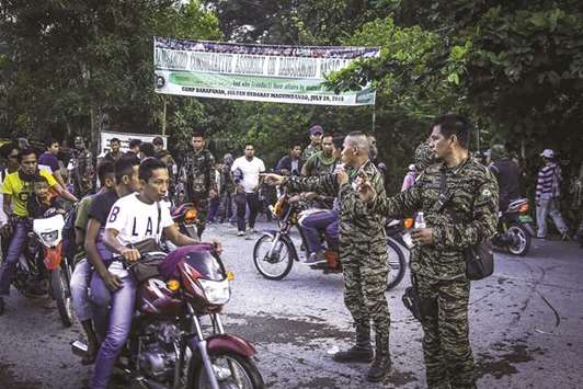 Moro Islamic Liberation Front (MILF) members secure Camp Darapanan in Sultan Kudarat, Maguindanao on the southern island of Mindanao yesterday.