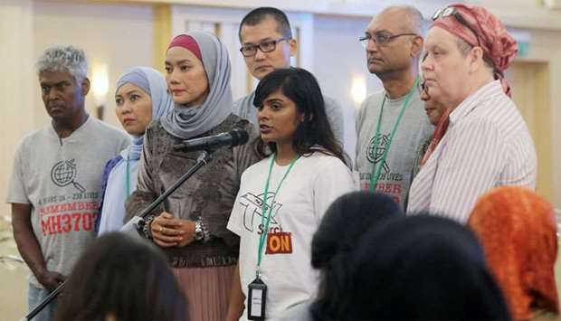 Family members speak to the media after an MH370 closed door meeting in Putrajaya