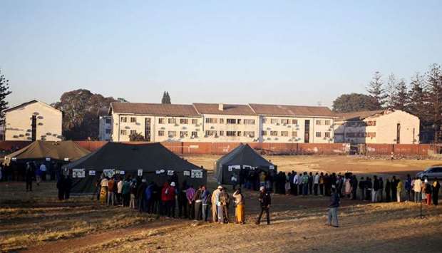 Zimbabwean voters queue to cast their ballots in the country's general elections in Harare