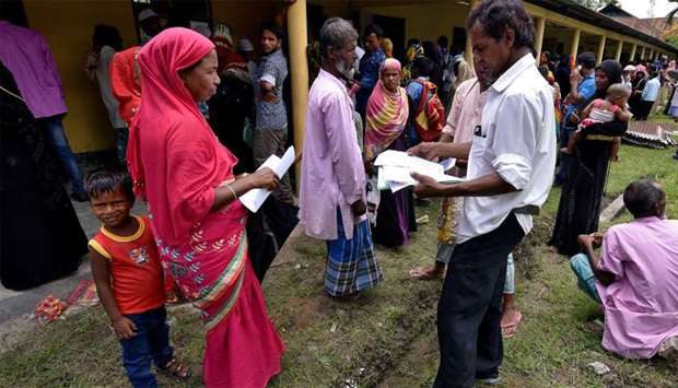 Villagers wait outside the National Register of Citizens (NRC) centre to get their documents verified by government officials, at Mayong Village in Morigaon district