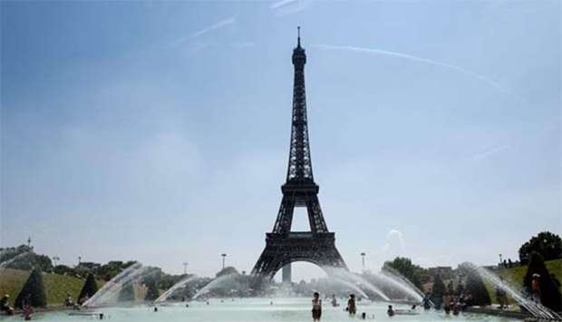 People cool themselves at the Trocadero Fountain in front of the Eiffel Tower in Paris last week.