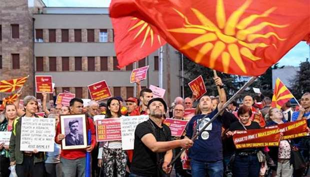 Demonstrators wave flags in front of the parliament building in Skopje during a protest last month against the new name of the country, the Republic of North Macedonia.