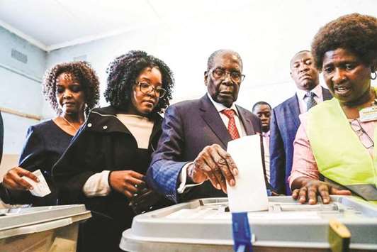 Former president Robert Mugabe, his daughter Bona and wife Grace cast their votes at a polling station in the Highfield district of Harare yesterday.