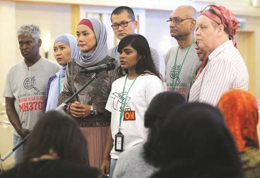 Family members speak to the media after an MH370 closed door meeting in Putrajaya yesterday.