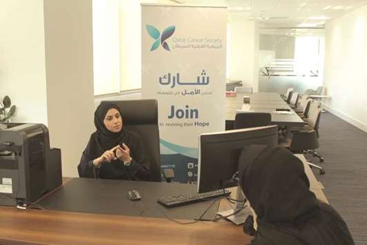 Heba Nassar, head of the Health Education Department at QCS, speaks to a visitor.