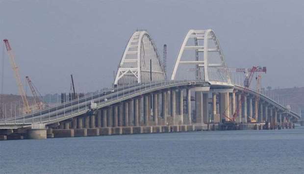 Cars drive along a bridge, which was constructed to connect the Russian mainland with the Crimean Peninsula across the Kerch Strait