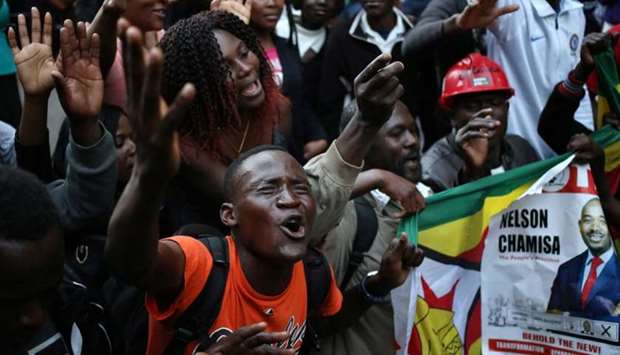 Supporters of the opposition Movement for Democratic Change party (MDC) of Nelson Chamisa, sing and dance in the street outside the party's headquarters following general elections in Harare, Zimbabwe