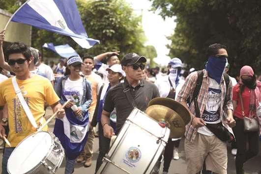 University students and doctors, dismissed from a public hospital for treating wounded anti-government protesters, march against President Daniel Ortega and his wife Vice President Rosario Murillo, in Leon, Nicaragua.