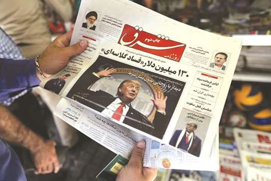 A man reads a newspaper with a picture of US President Donald Trump in Tehran yesterday.