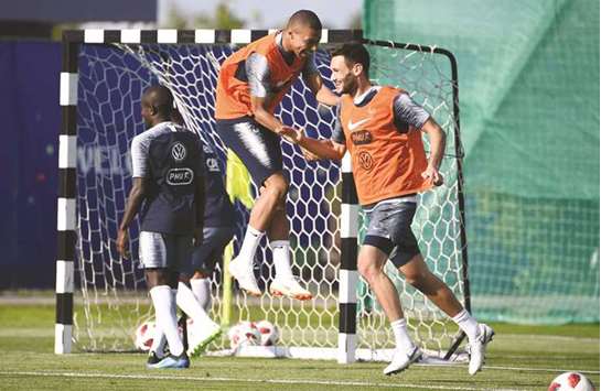 Franceu2019s forward Kylian Mbappe (left) and goalkeeper Hugo Lloris are in good spirits during a training session at the Glebovets stadium in Istra, some 70km west of Moscow yesterday. (AFP)
