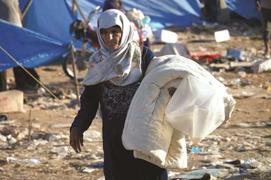 A displaced Syrian from the Daraa province fleeing shelling by pro-government forces is seen in a makeshift camp to cross the Jordanian border, near the town of Nasib, southern Syria.