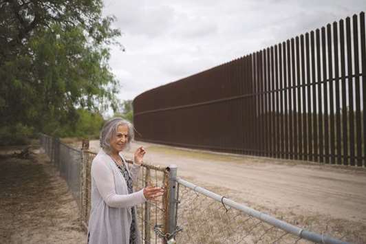Eloisa Tamez stands in her backyard in San Benito, Texas.