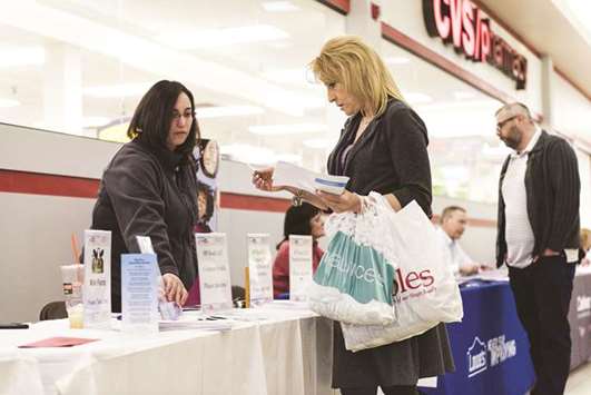 A job seeker (right) speaks with a representative at the Laconia Job & Resource Fair, hosted by the New Hampshire Employment Security, at Belknap Mall in Belmont, New Hampshire (file). If data due on Friday from the Labour Department shows thereu2019s a marked slowdown in employment, it would indicate that u201cthe business sector may have gone on hold with its investment and hiring plans given the noise around protectionism.u201d