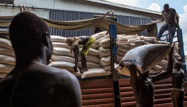 Employees at World Food Programme (WFP) warehouse, situated near Juba Airport, prepare food sacks on July 2, 2018 which will be loaded on planes in order to airdrop across South Soudan