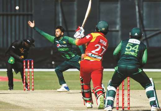 Pakistanu2019s Mohamed Nawaz attempts to stop a Solomon Mire shot during the T20 tri-series at Harare Sports Club yesterday. (AFP)