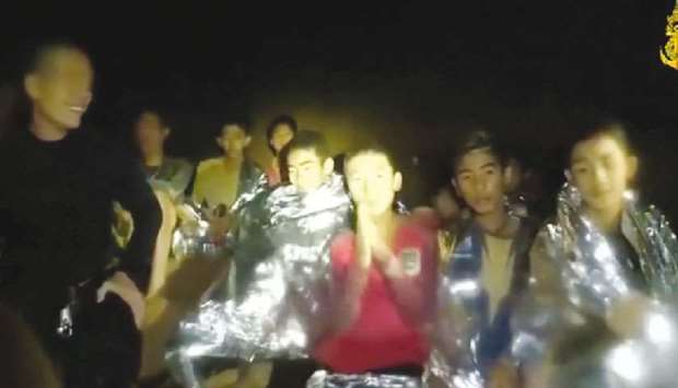 Boys from the under-16 soccer team trapped inside Tham Luang cave greet members of the Thai rescue team in Chiang Rai in this still image taken from a video by Thai Navy Seal.