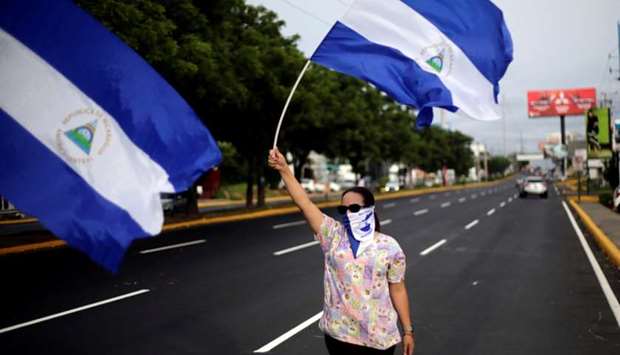 A demonstrator waves a Nicaraguan national flag during a protest against President Daniel Ortega's government in Managua, Nicaragua