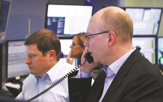 Traders are seen at the Frankfurt Stock Exchange. The DAX 30 rose 1.2% to 12,464.29 points yesterday.