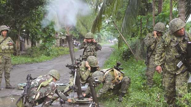 Soldiers from the Philippines Armyu2019s 2nd Mechanized Infantry Division fire mortars towards the positions of members of the Bangsamoro Islamic Freedom Fighters militants during clashes in Maguindanao.
