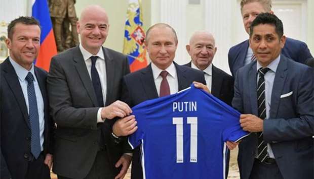 President Vladimir Putin poses for a picture with (L-R) Lothar Matthaeus, Gianni Infantino, First Vice President of the Russian Football Union Nikita Simonyan, former Danish player Peter Schmeichel and former Mexican player Jorge Campos during a meeting at the Kremlin in Moscow on Friday.