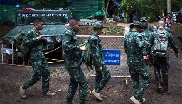Thai soldiers make their way near the Tham Luang cave as rescue operations continue at the Khun Nam Nang Non Forest Park in Chiang Rai province on Friday.