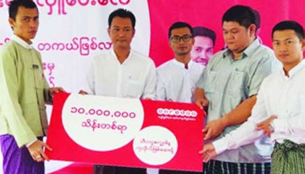 Ooredoo Myanmar officials hand over the donation to Sitagu Cakkhudana Hospital.