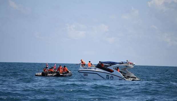 Rescuers search an area near Phuket, as rescue operations continue for missing tourists following a boat accident on Thursday.