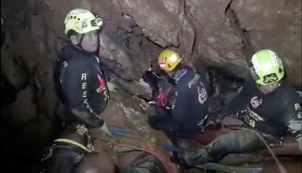 Ruamkatanyu Foundation rescuers are seen trying to find alternative entrance to the Tham Luang cave complex.