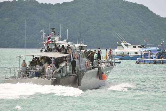 A Thai Royal Navy boat is seen during a searching operation for missing passengers of a capsized tourist boat at a pier in Phuket yesterday.