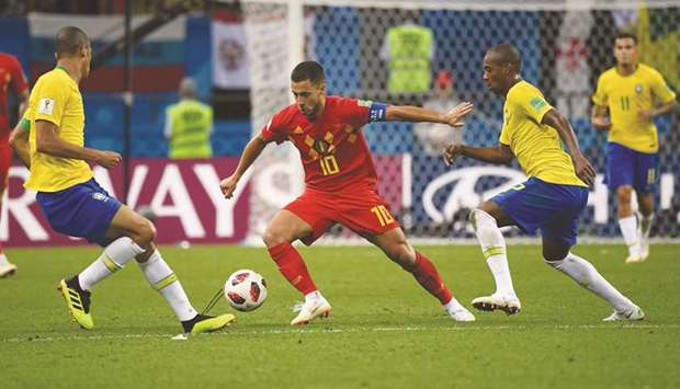 Belgiumu2019s Eden Hazard (centre) controls the ball during the FIFA World Cup quarter-final against Brazil in Kazan, Russia, on Friday. (AFP)