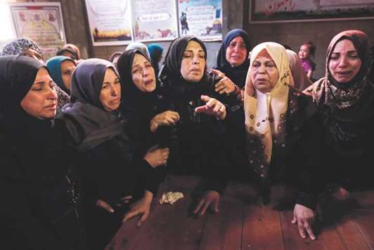 Mourners are seen during the funeral of 22-year-old Mohamed Abu Halima in Gaza City, yesterday.
