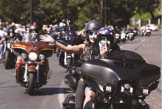 Participants of a motorcycle parade ride their bikes through the centre of Prague yesterday to celebrate the 115th anniversary of the Harley-Davidson trademark.